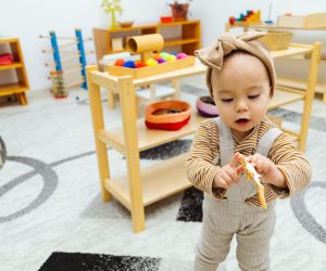 Toddler holding shark toy figure